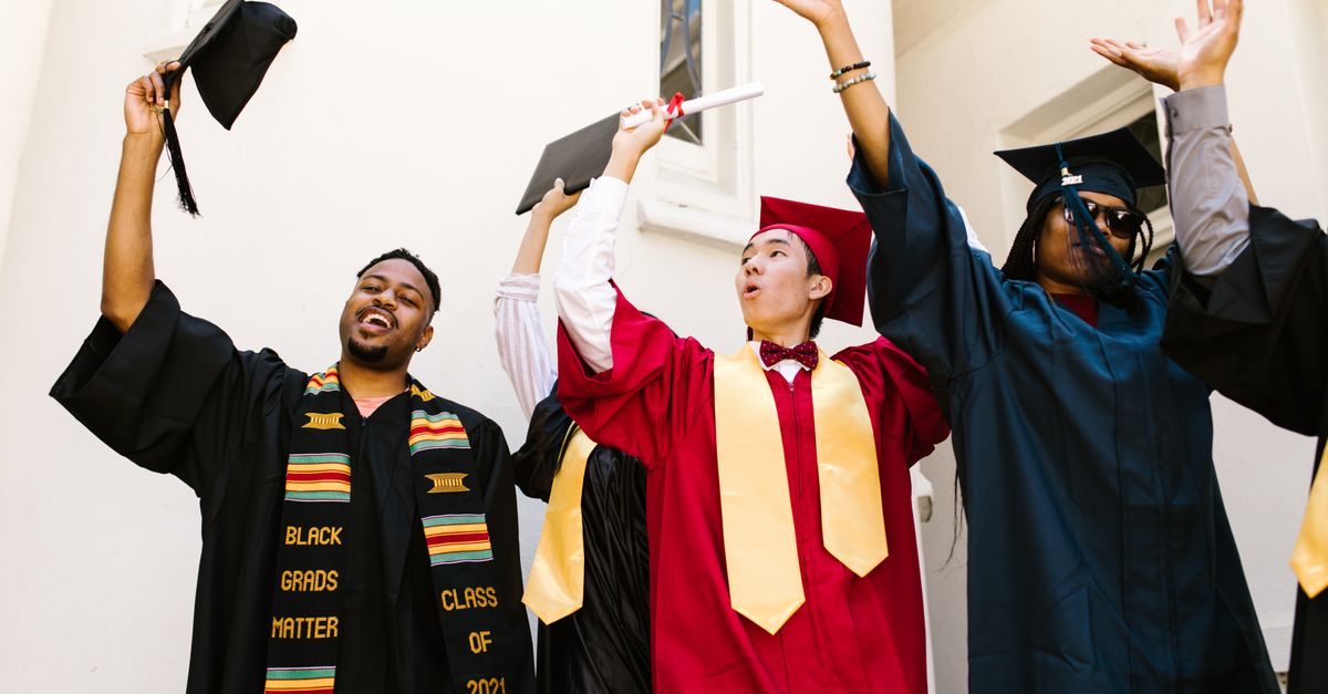 Graduates celebrating with caps and diplomas, expressing joy and achievement.